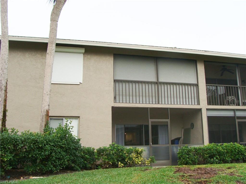 5693 Rattlesnake Hamm Road, Unit A204 Naples, FL 34113 - Photo 25 of 29 a front view of a house with garden