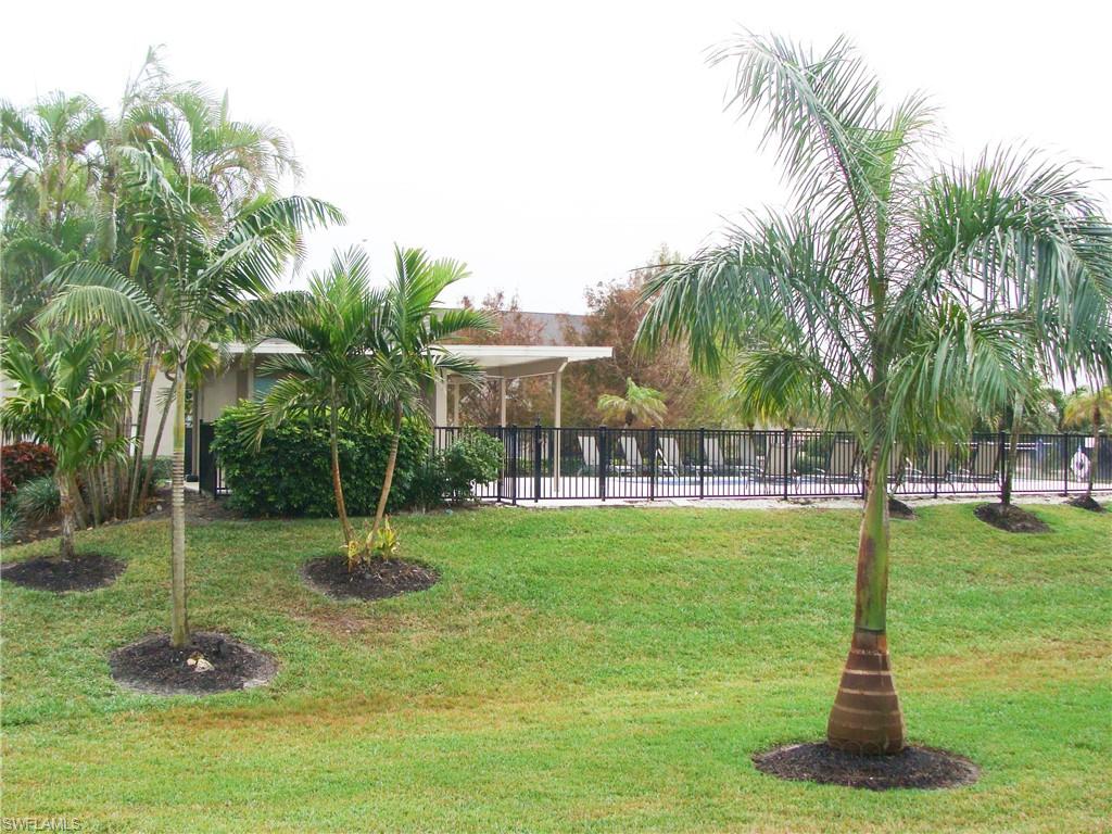5693 Rattlesnake Hamm Road, Unit A204 Naples, FL 34113 - Photo 26 of 29 a view of a fountain in a yard with palm trees