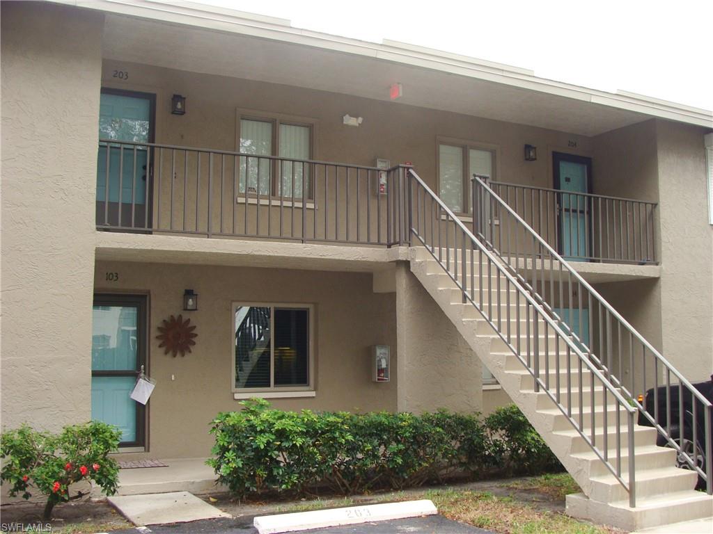5693 Rattlesnake Hamm Road, Unit A204 Naples, FL 34113 - Photo 27 of 29 a view of staircase with white walls and windows