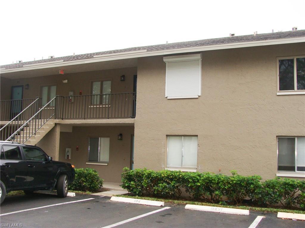 5693 Rattlesnake Hamm Road, Unit A204 Naples, FL 34113 - Photo 28 of 29 a front view of a house with garage