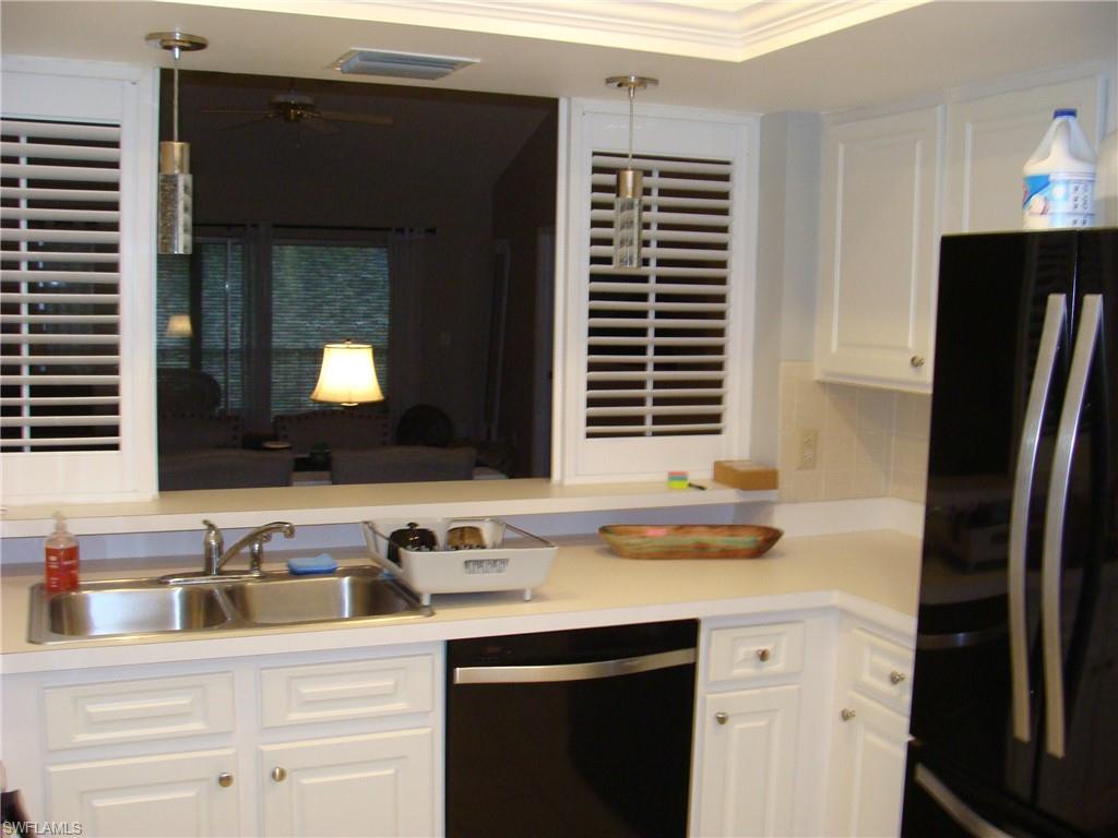 5693 Rattlesnake Hamm Road, Unit A204 Naples, FL 34113 - Photo 3 of 29 a bathroom with a sink and a mirror