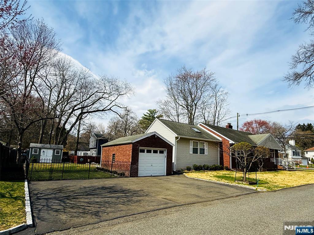 216 Cedar Lane Closter, NJ 07624 - Photo 1 of 15 a front view of a house with a yard