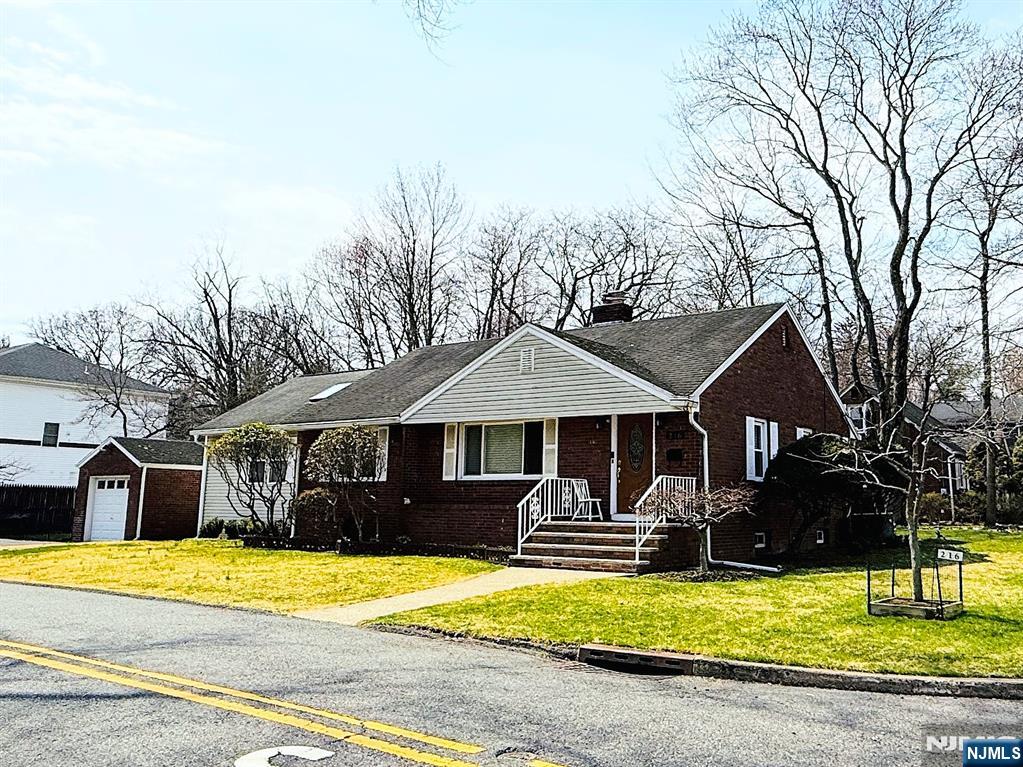 216 Cedar Lane Closter, NJ 07624 - Photo 2 of 15 a front view of a house with swimming pool