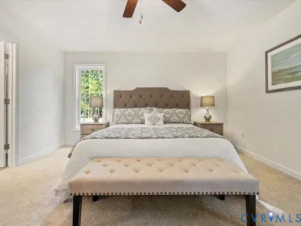 a bedroom with a large bed and a chandelier