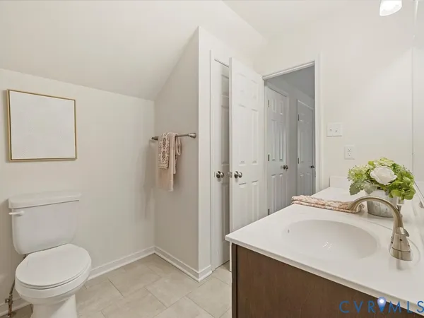 an empty room with closet and a bathroom