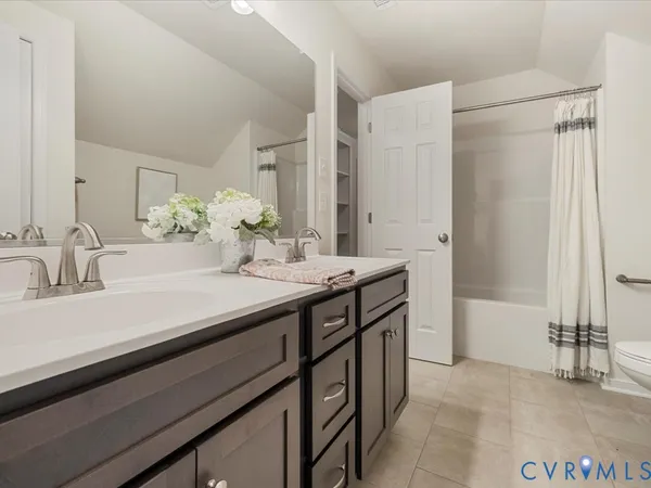 a view of a house with a wooden deck and a yard