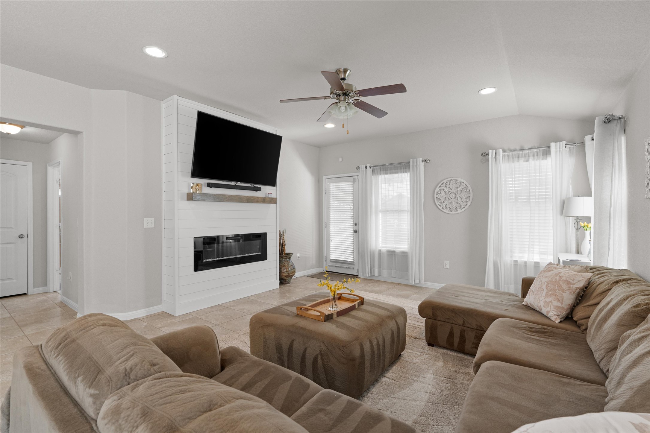 524 Longhorn Cavern Road Leander, TX 78641 - Photo 14 of 34 Living area with a ceiling fan, light tile patterned floors, recessed lighting, and a fireplace