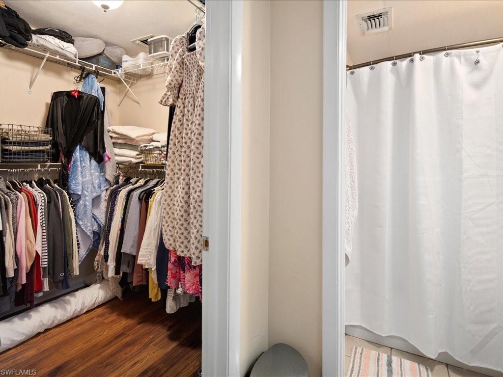 4070 Looking Glass Lane, Unit 3106 Naples, FL 34112 - Photo 14 of 29 a view of walk in closet with clothes and shoes