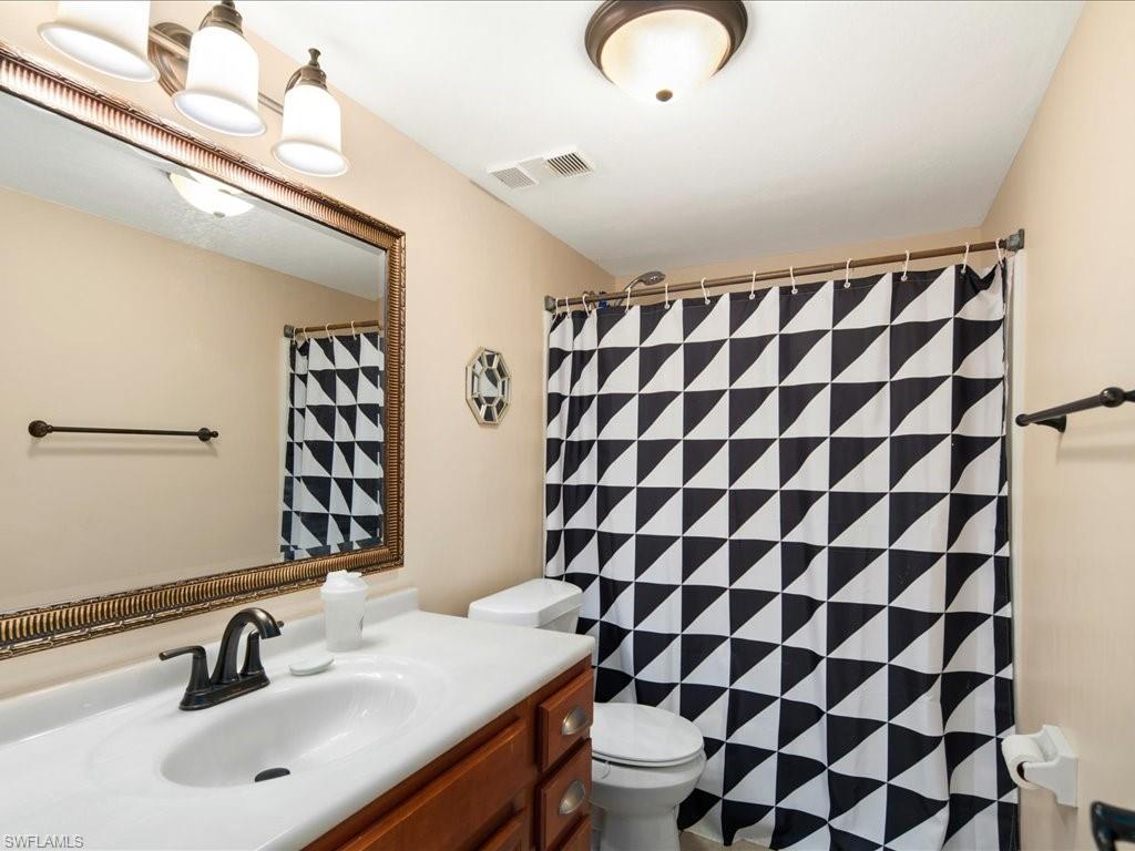 4070 Looking Glass Lane, Unit 3106 Naples, FL 34112 - Photo 21 of 29 a bathroom with a sink toilet and shower