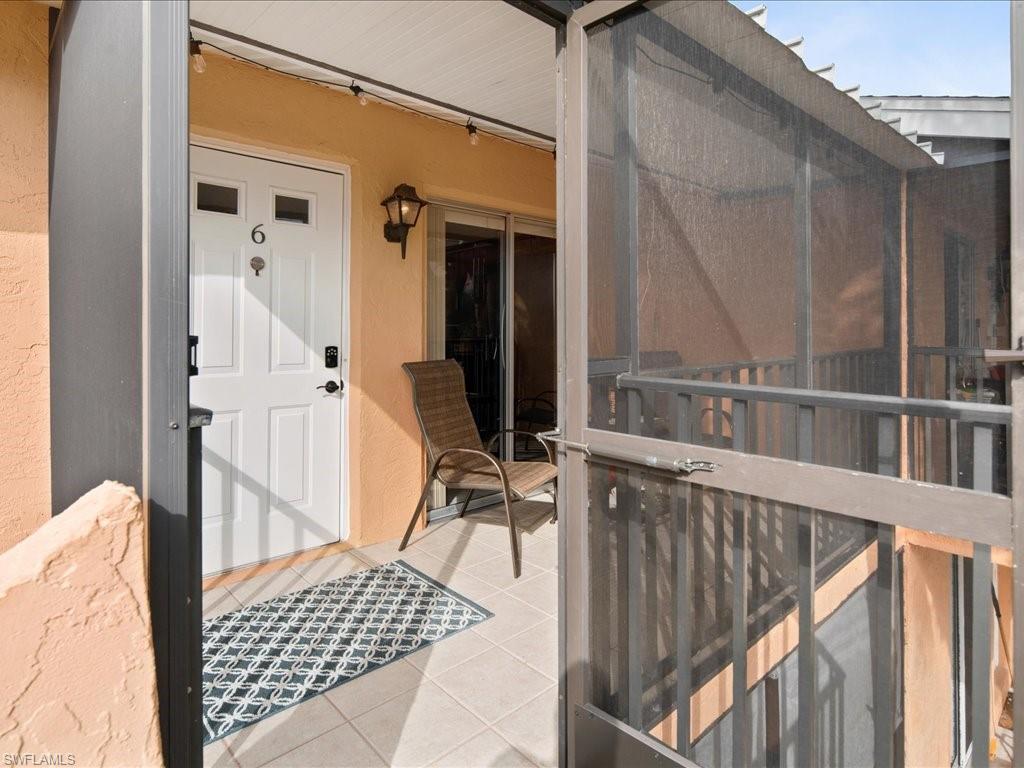 4070 Looking Glass Lane, Unit 3106 Naples, FL 34112 - Photo 3 of 29 a balcony with table and chairs