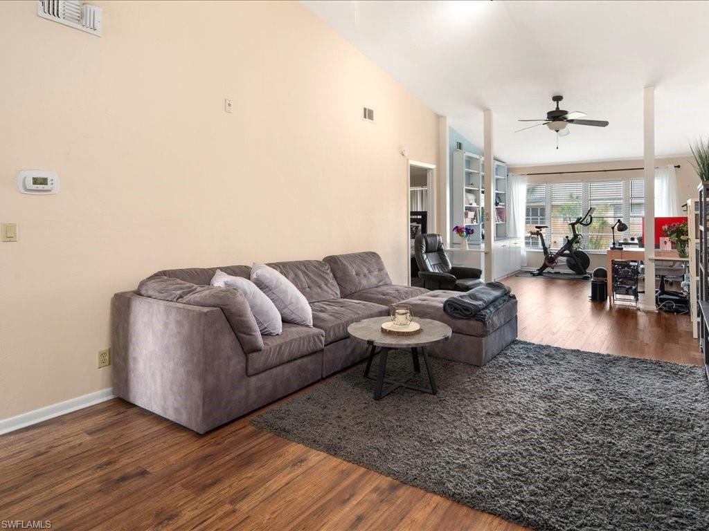4070 Looking Glass Lane, Unit 3106 Naples, FL 34112 - Photo 6 of 29 a living room with furniture and wooden floor
