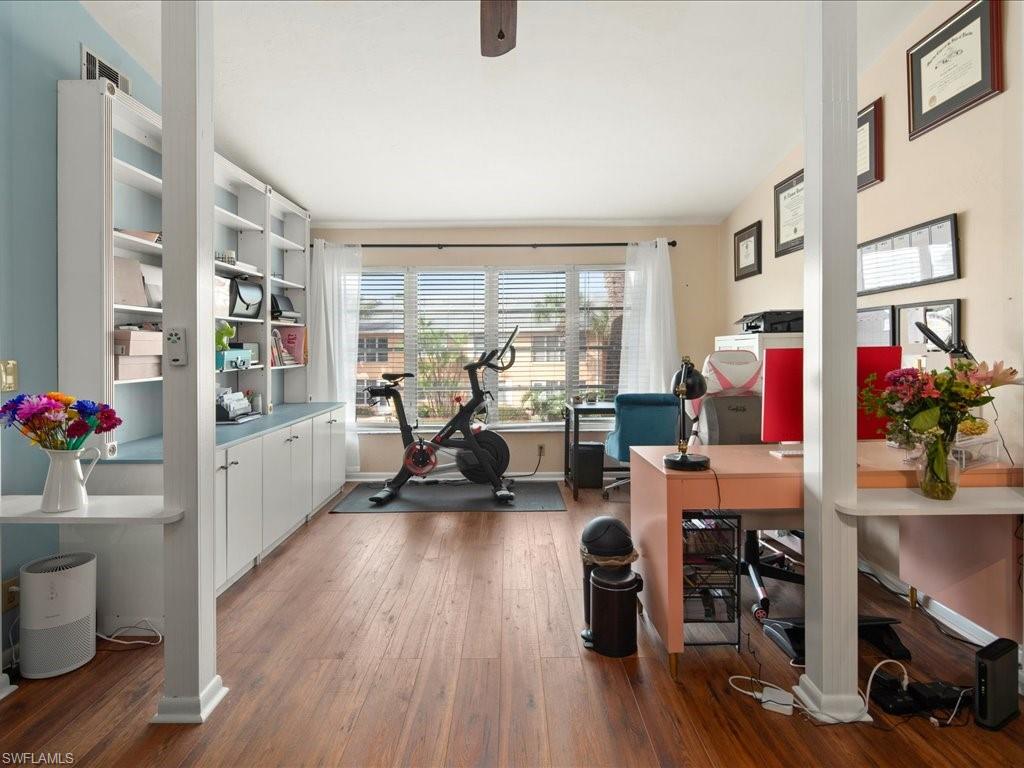 4070 Looking Glass Lane, Unit 3106 Naples, FL 34112 - Photo 7 of 29 a living room with furniture and a wooden floor