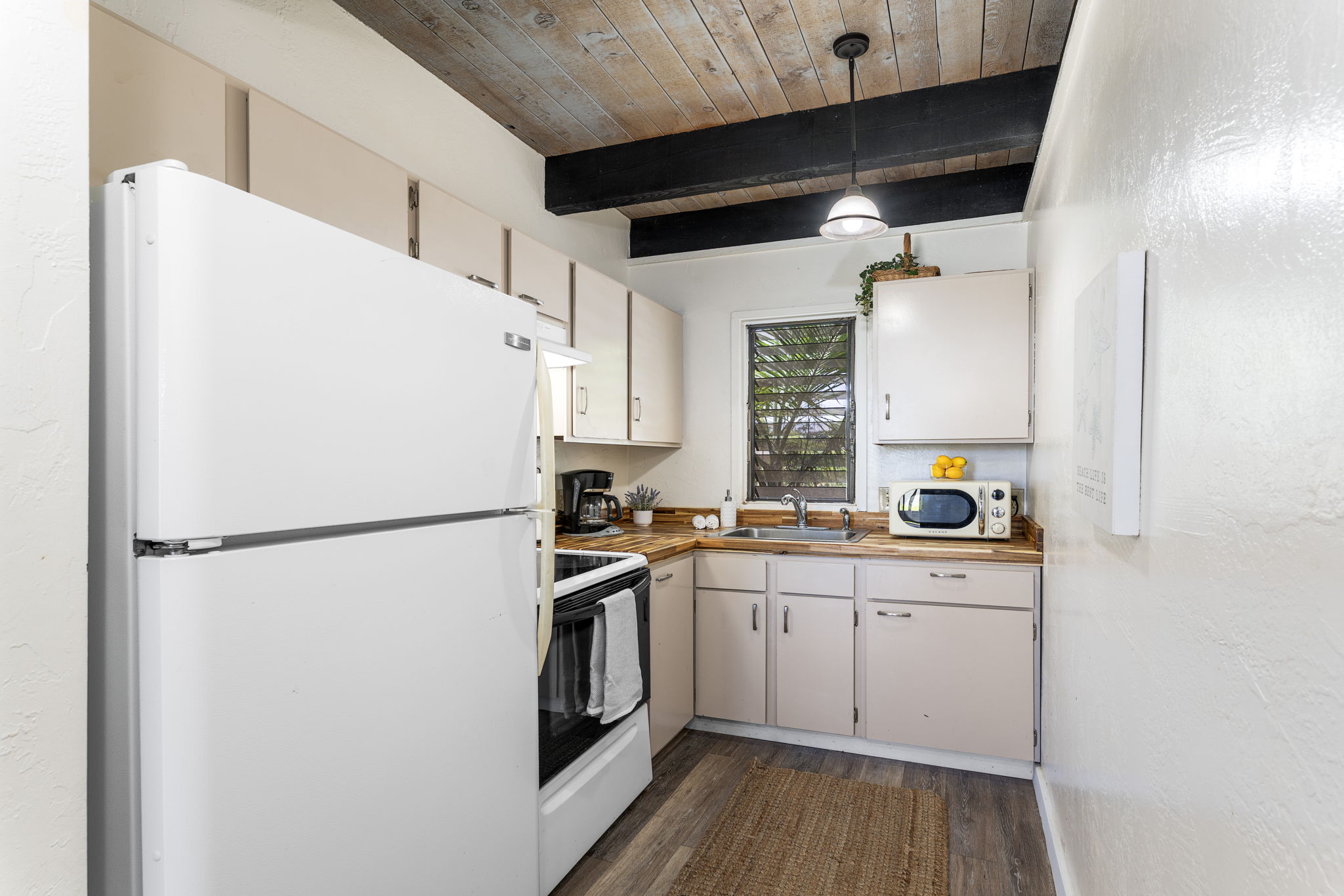 76-6259 Alii Drive, Unit 332 Kailua-Kona, HI 96740 - Photo 13 of 21 a white refrigerator freezer sitting inside of a kitchen