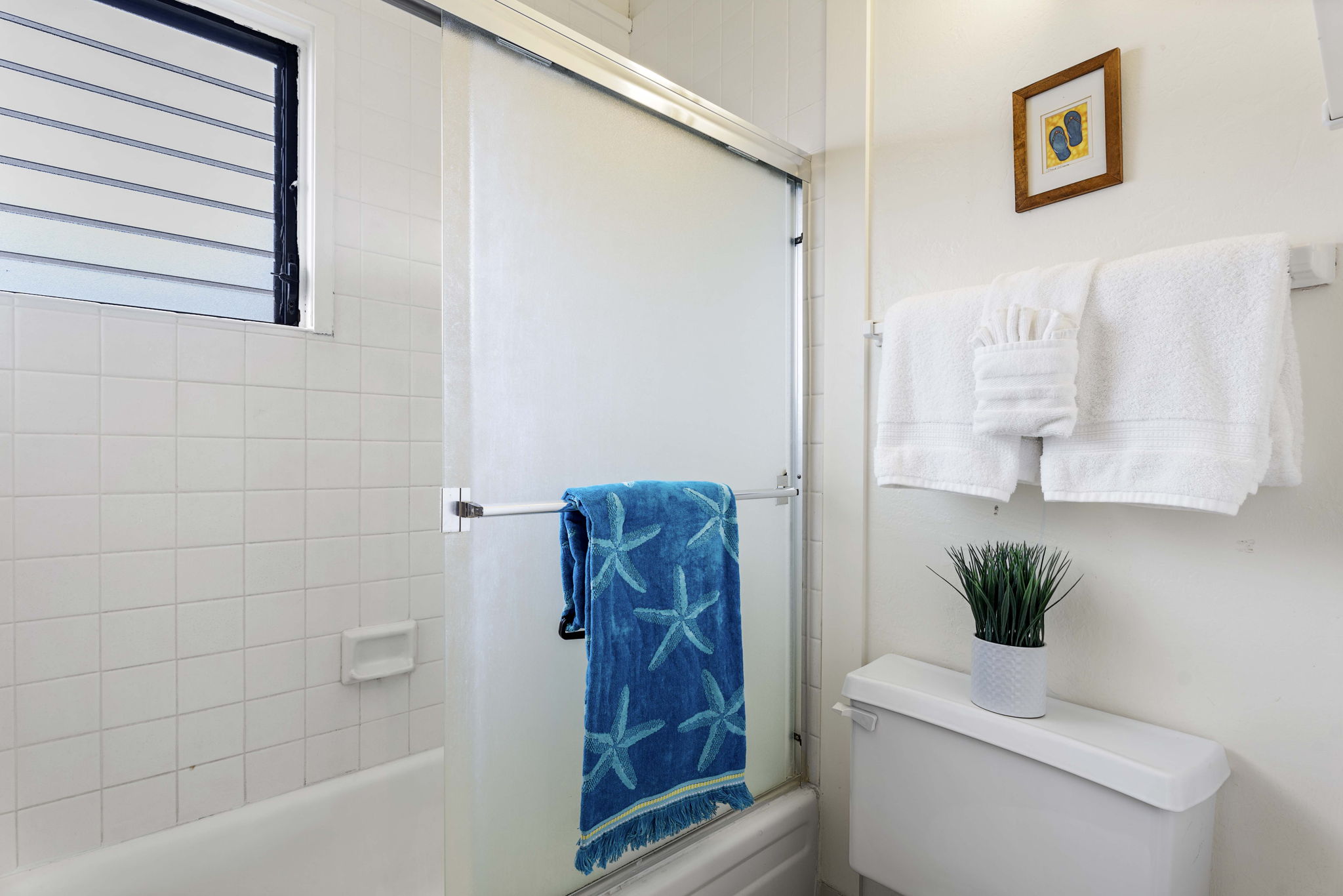 76-6259 Alii Drive, Unit 332 Kailua-Kona, HI 96740 - Photo 17 of 21 a bathroom with a toilet and a shower