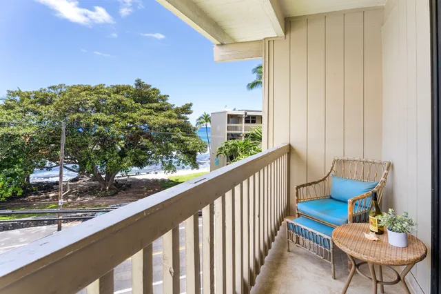 a view of a chairs and table in a balcony