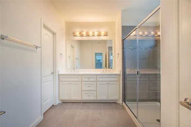 a spacious bathroom with a shower and a sink