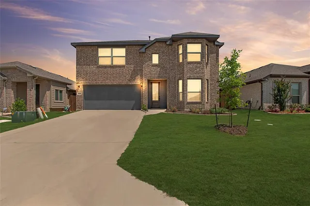 a brick building with a yard in front of it