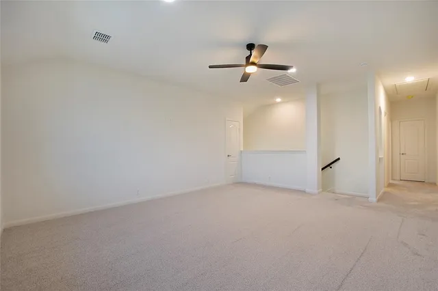 an empty room with closet and windows