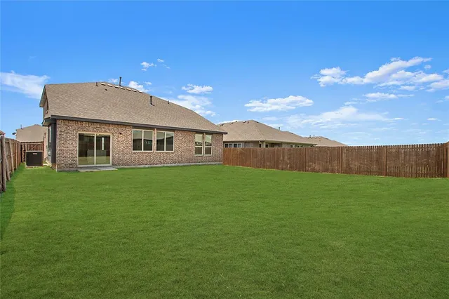 a view of an house with backyard space and balcony