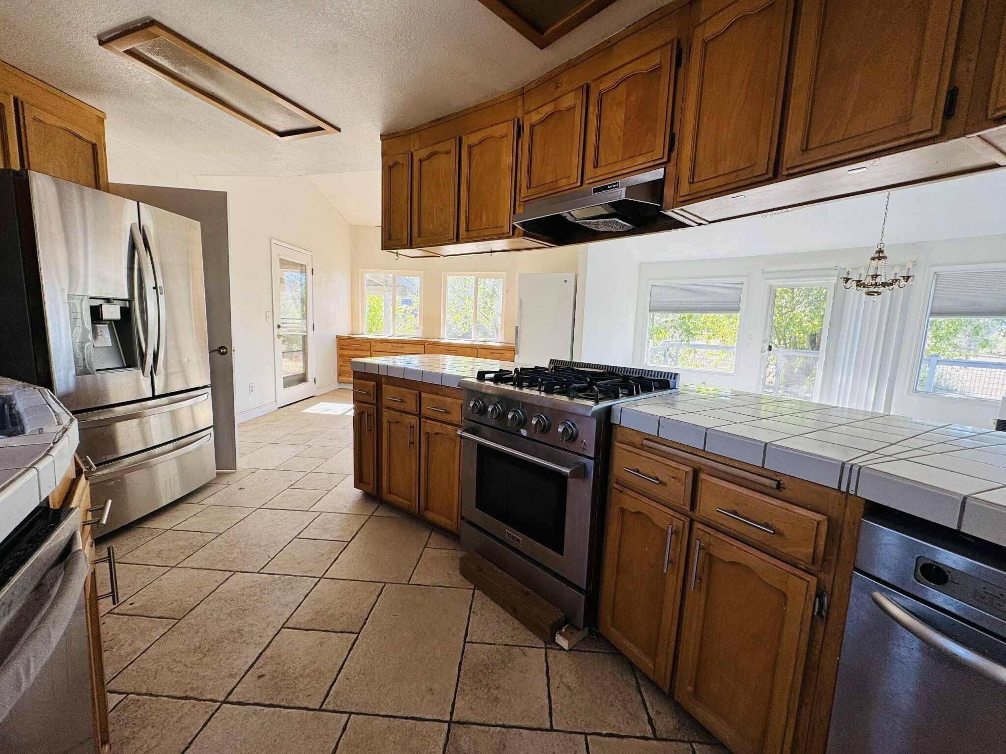 21283 Lela Lane Redding, CA 96003 - Photo 11 of 23 a kitchen with stainless steel appliances granite countertop a stove a refrigerator and a sink