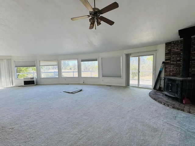 a view of a livingroom with a ceiling fan and window