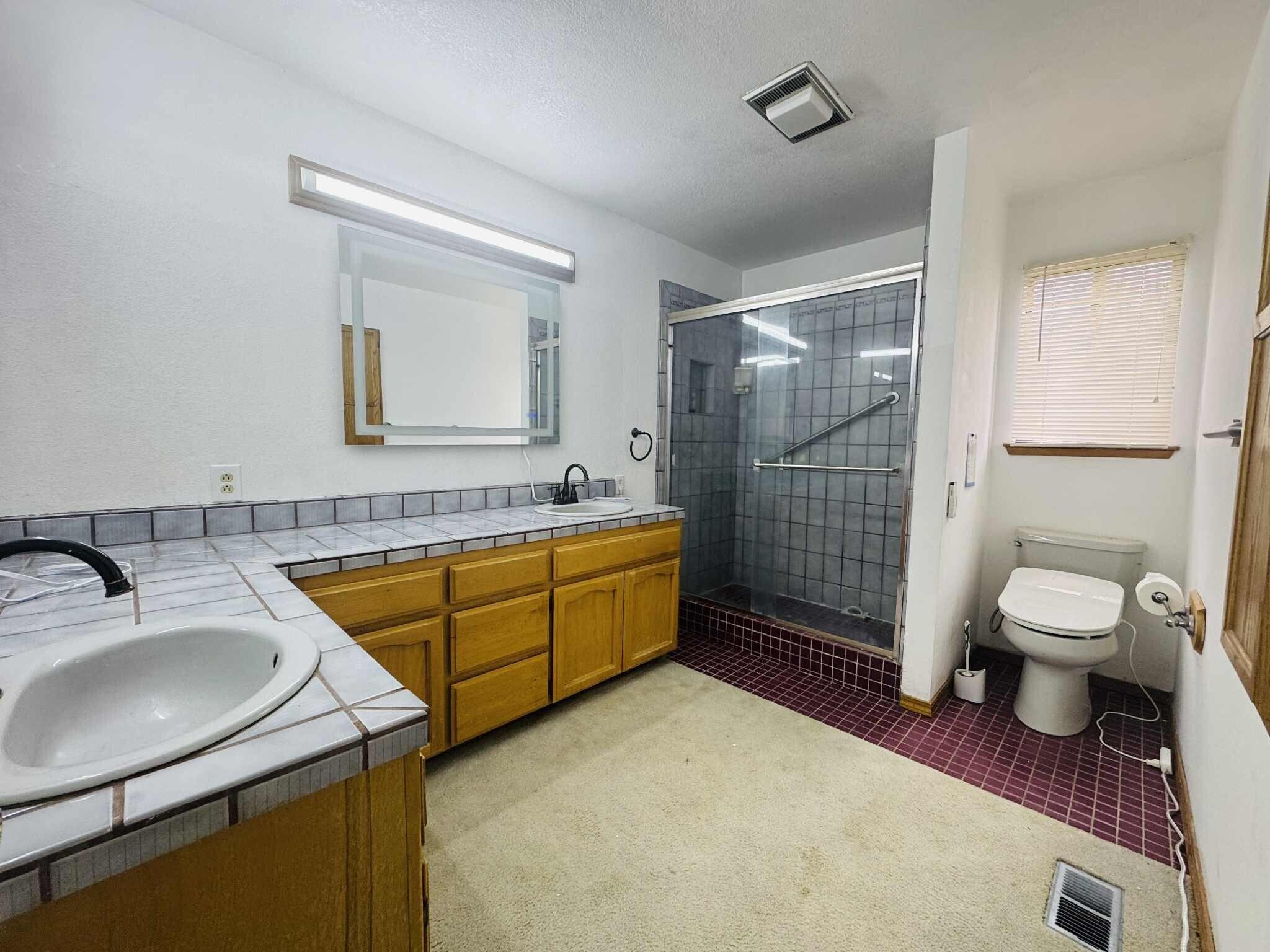 21283 Lela Lane Redding, CA 96003 - Photo 21 of 23 a bathroom with a sink toilet and shower