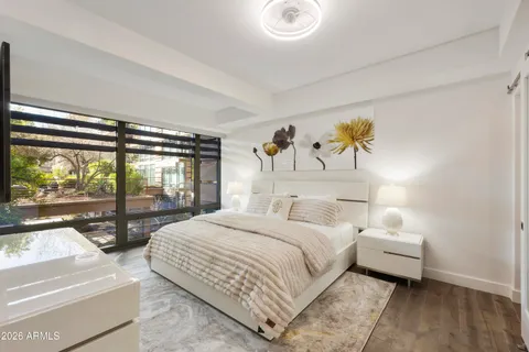 a bedroom with a bed and a large window