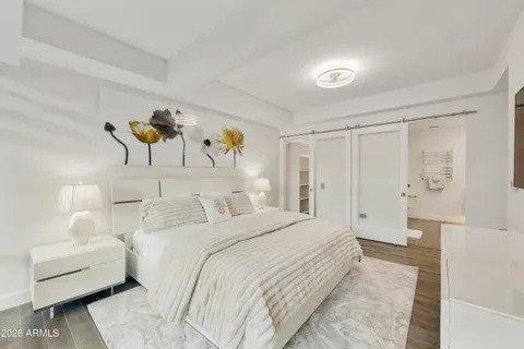 a bedroom with a bed and a couch