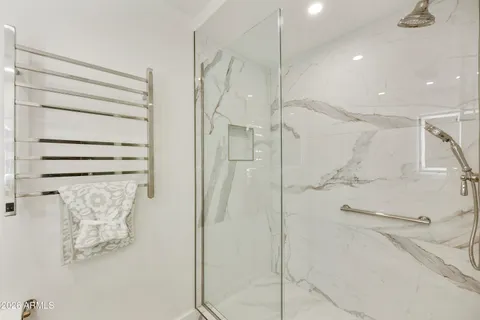 a bathroom with a shower and a glass door