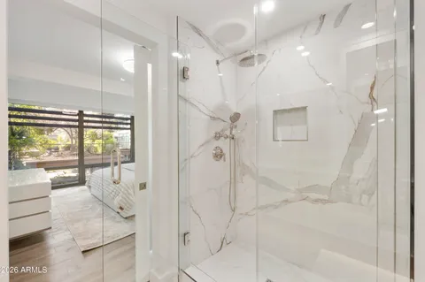 a bathroom with a glass shower door and a glass door shower
