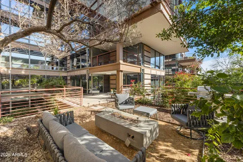 a view of a patio with couches table and chairs and potted plants