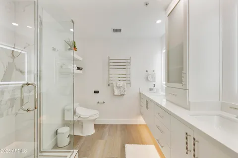 a bathroom with a double vanity sink toilet and shower