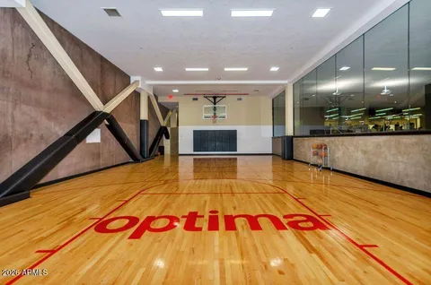 a living room with stainless steel appliances with kitchen countertops and a couch