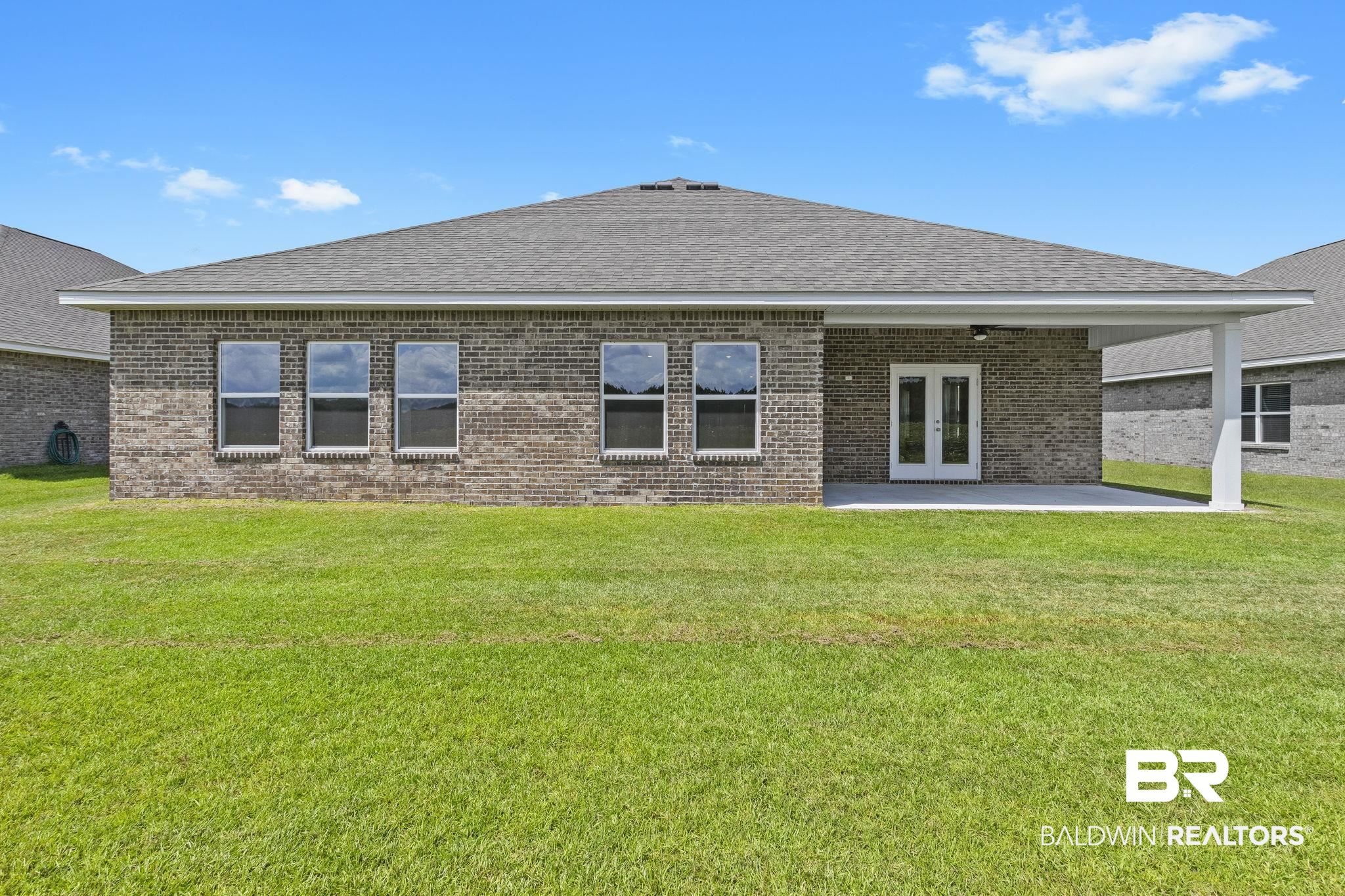 11303 Genuine Risk Circle Daphne, AL 36526 - Photo 70 of 100 Rear view of house featuring a yard, a patio area, and french doors