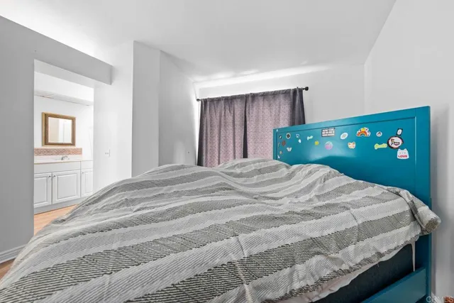 a bedroom with a bed and a tv