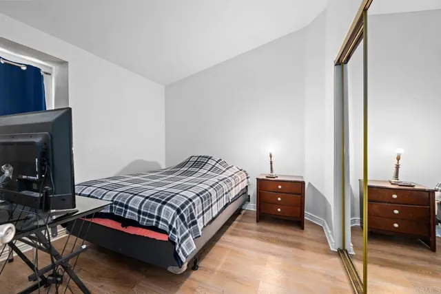 a bedroom with a bed and a lamp