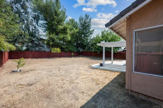 a backyard of a house with table and chairs