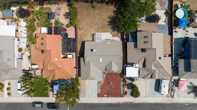 an aerial view of residential houses with outdoor space