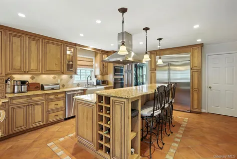 a kitchen with a stove a sink a dining table and chairs