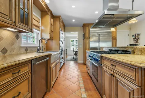 a kitchen with stainless steel appliances granite countertop a sink and a counter