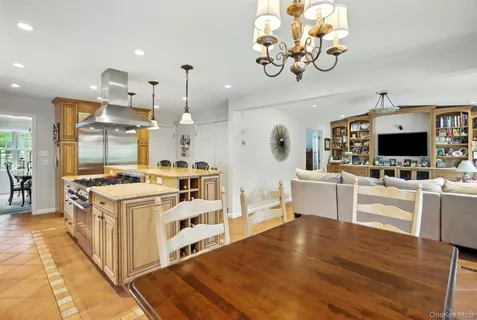 a large kitchen with stainless steel appliances kitchen island granite countertop a stove and a view of living room