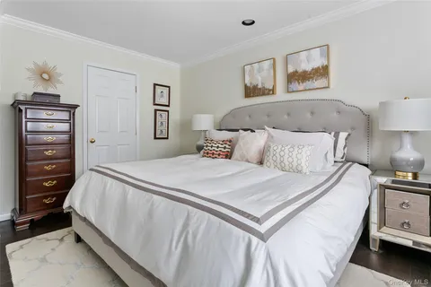 a bedroom with a bed and a night stand