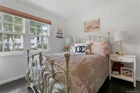 a bed sitting in a bedroom next to a window