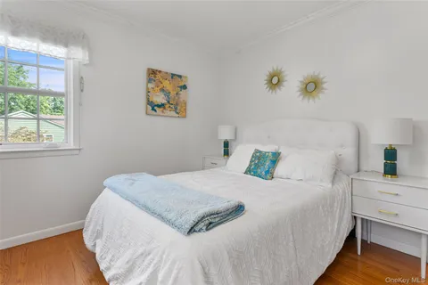 a bedroom with a bed a dresser and a window