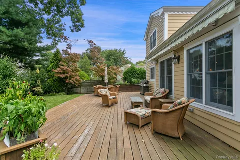 a view of a patio with couches table and chairs and potted plants