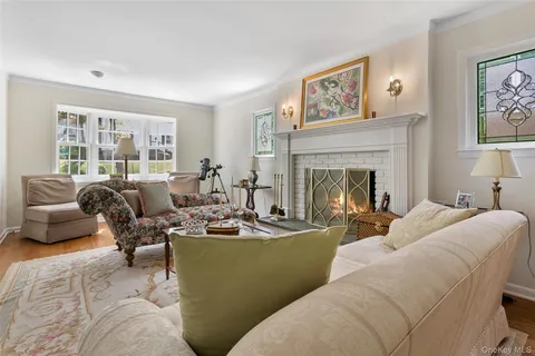 a living room with furniture large window and fireplace