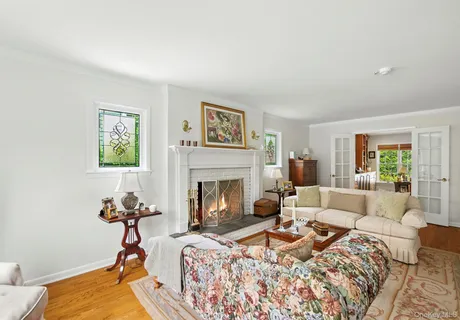 a living room with furniture a fireplace and a table