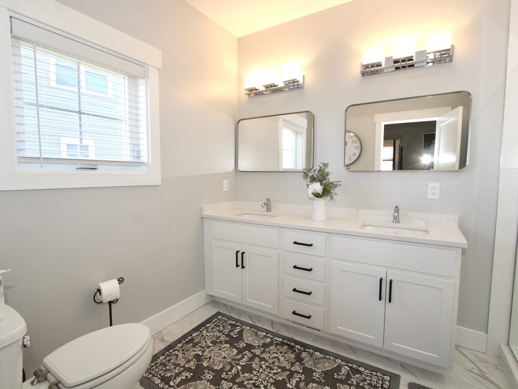 10 Salisbury Hill Boulevard, Unit 75 Worcester, MA 01609 - Photo 15 of 29 a bathroom with a toilet a sink a mirror a window and vanity