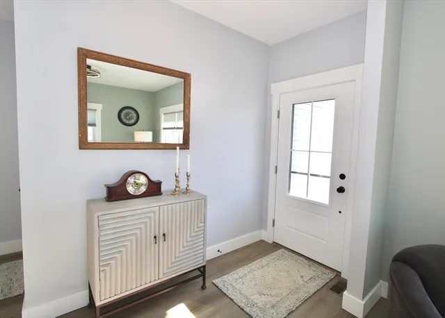 a view of an entryway with wooden floor