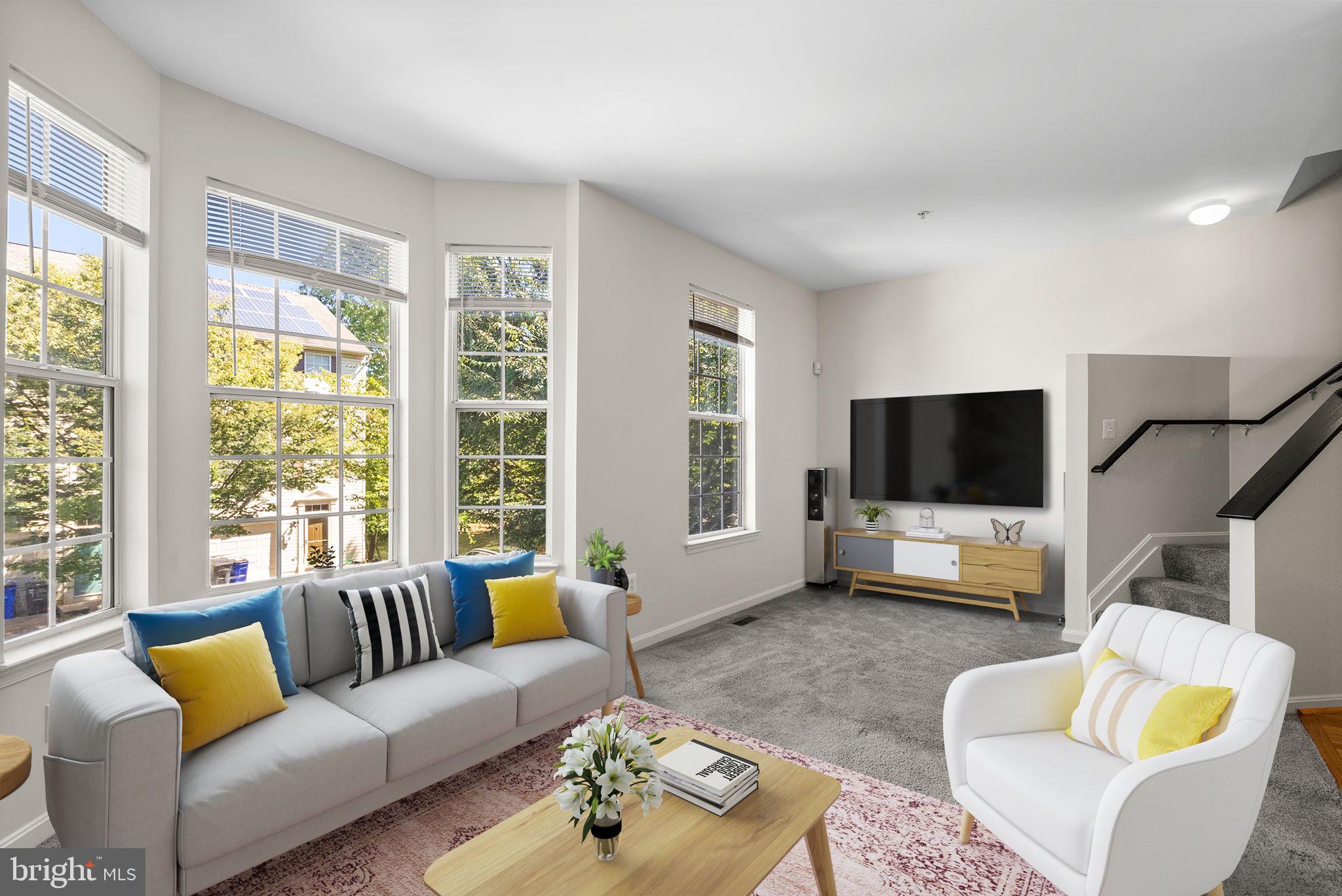6710 Tranquil Way Elkridge, MD 21075 - Photo 18 of 49 a living room with furniture a flat screen tv and a large window